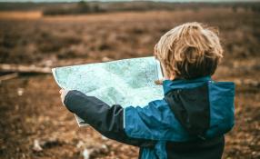 Image of boy holding a map