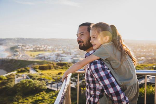 This is an image of a man and a child enjoying a view