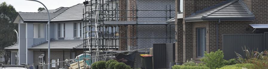 Image of residential brick building with scaffolding 